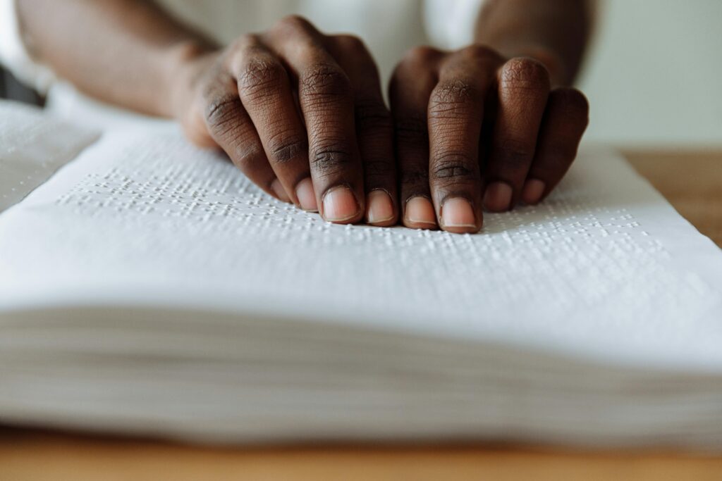 person reading using braille